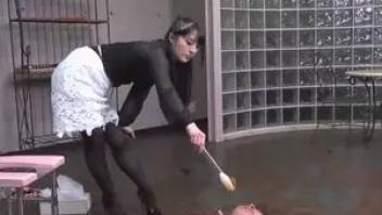 Asian girl feeds two guys with their poop